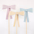 Mint, yellow and peach paper bow cake toppers on bamboo skewers. 