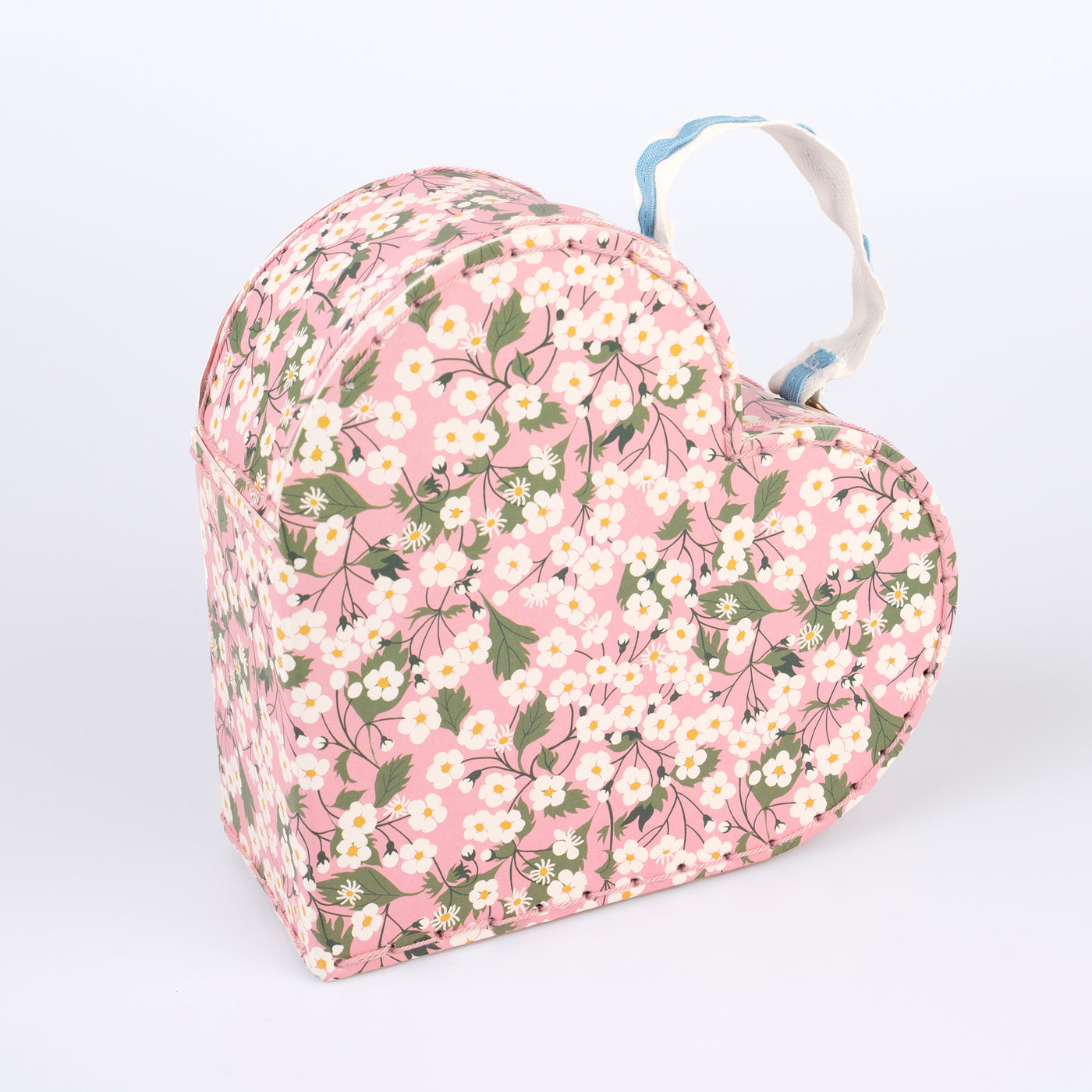 Two different sized heart-shaped suitcases made from stitched card with lamination. The smaller case can be stored inside the larger.  Each suitcase features a different Liberty floral print design, with pink tones, on the outside.