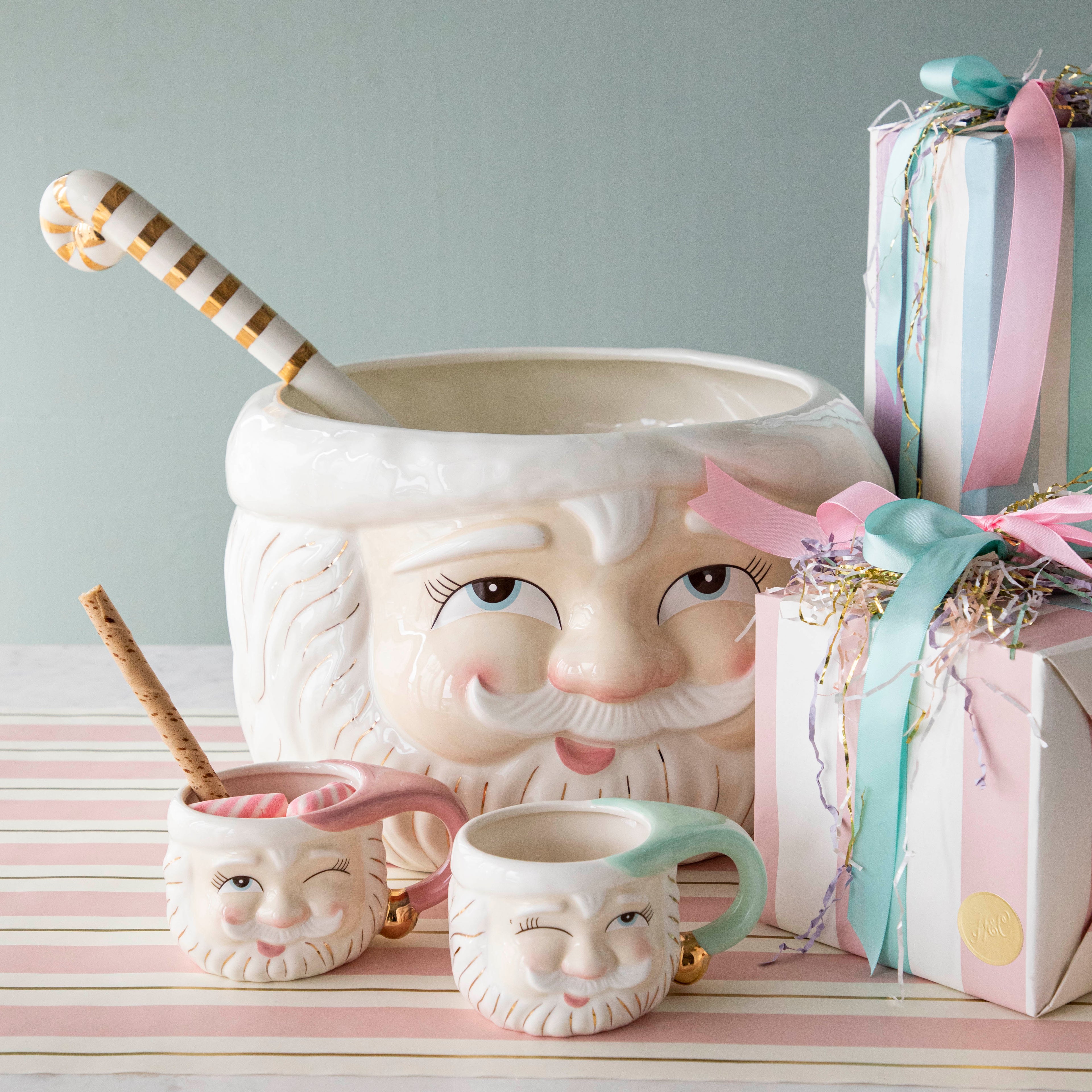 Papa Noel Punch Bowl with a Pink Papa Noel Mug and a Mint Papa Noel Mug in front of it.  