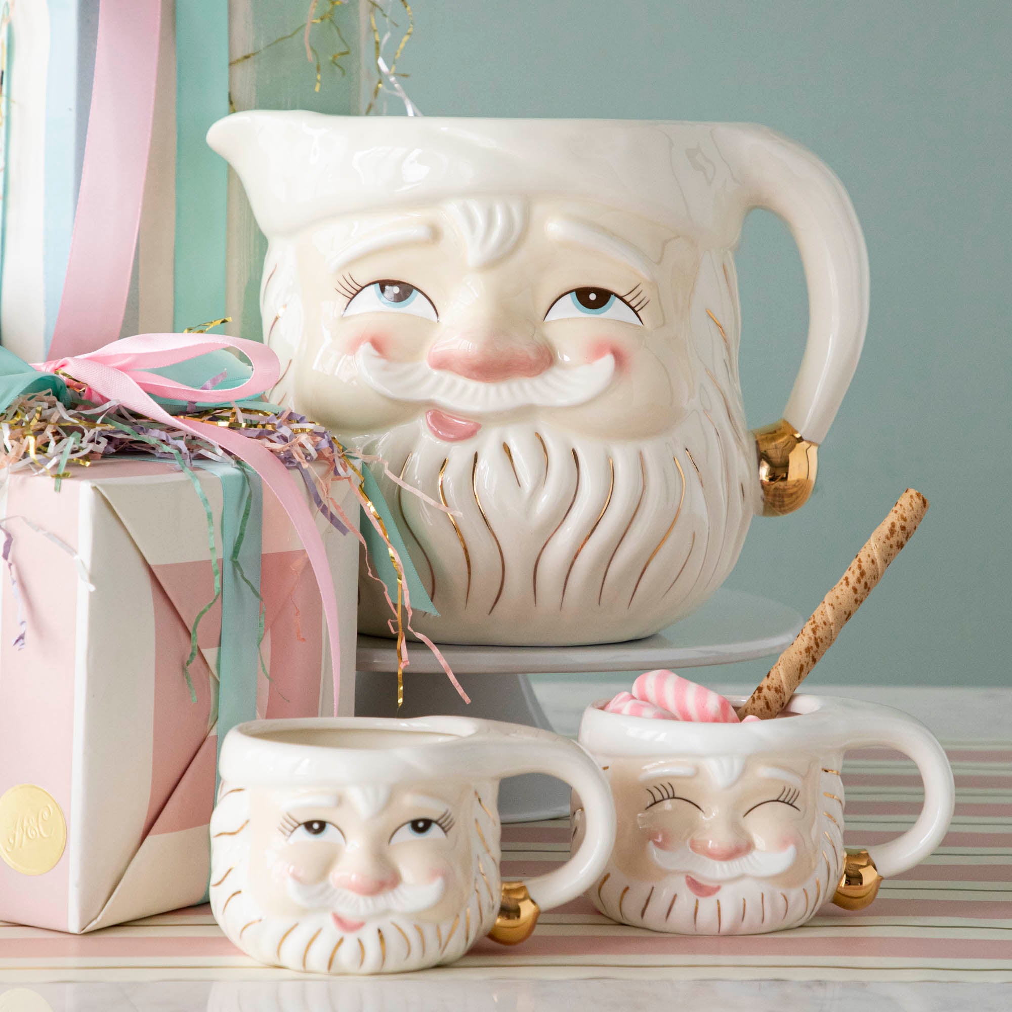 Two Cream Papa Noel mugs from Glitterville with a Papa Noel Pitcher behind them.