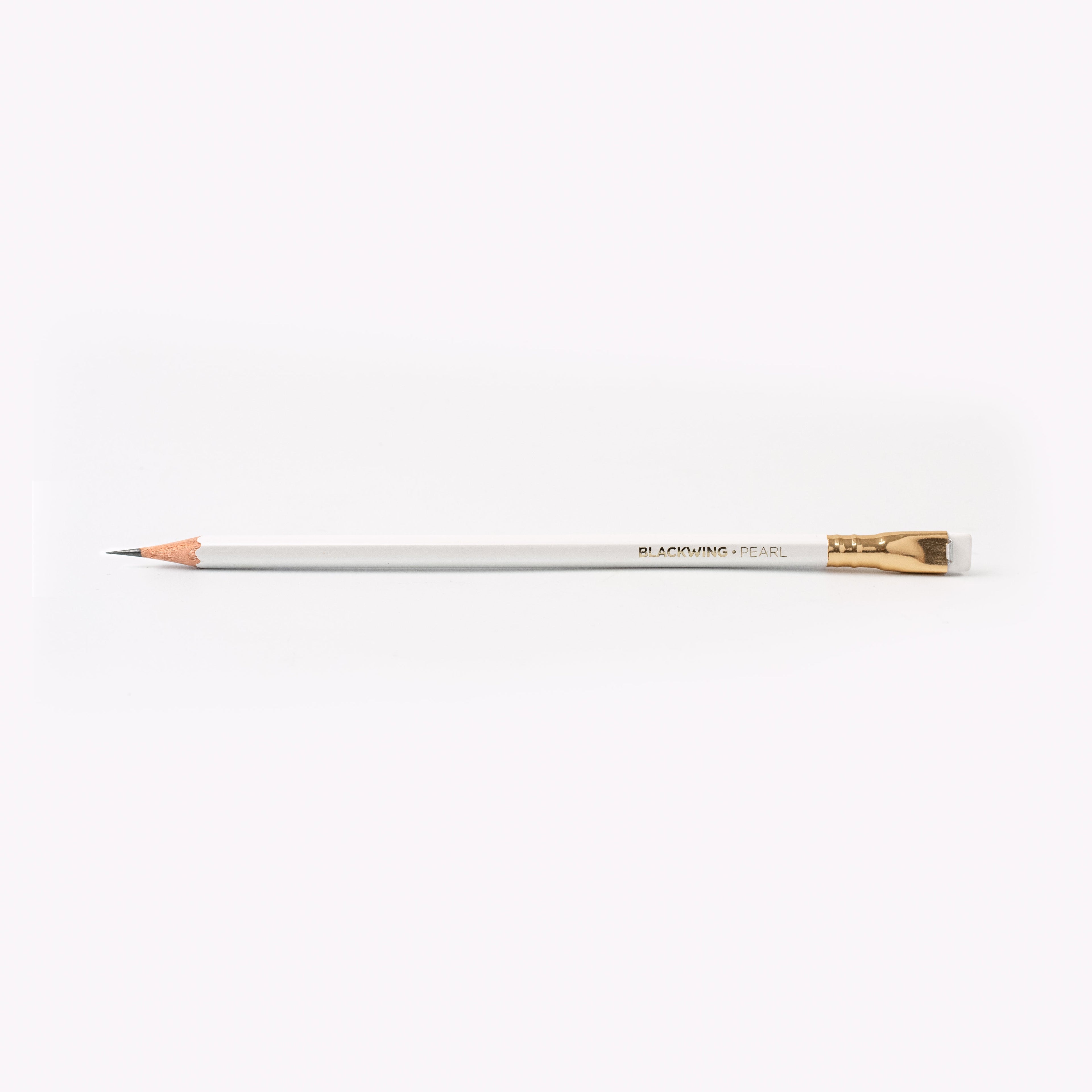 A Blackwing Pearl Pencils Set of 12 with a graphite core and white eraser next to its packaging box on a white background.