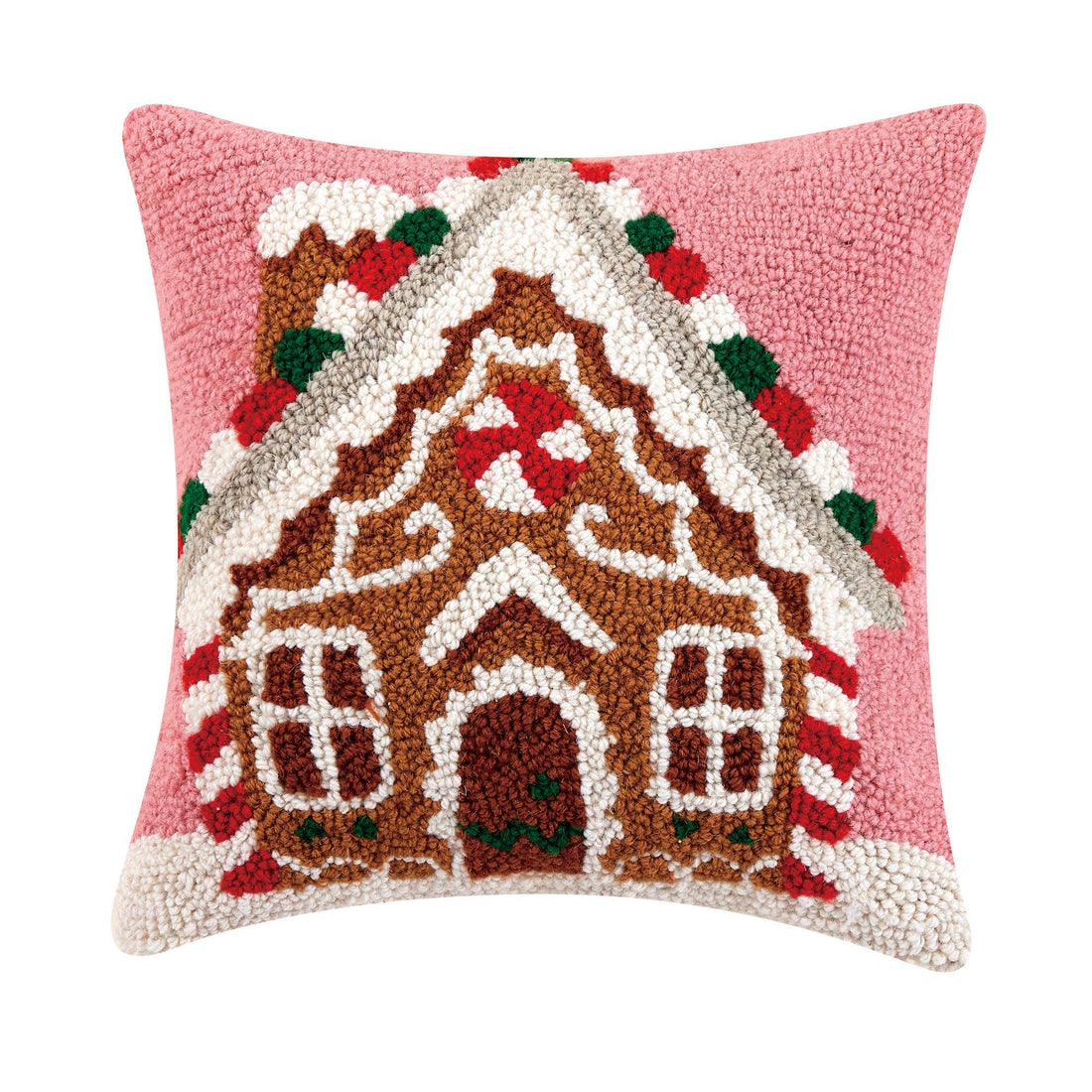 A hooked, Gingerbread House Holiday pillow with a pink background.