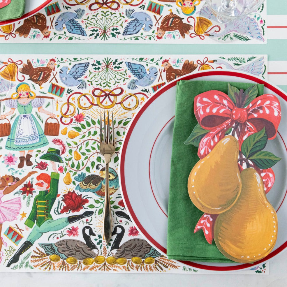 A Twelve Days of Christmas themed place setting featuring a Pears Table Accent resting on the plate.