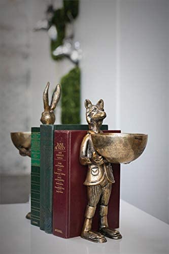 A statue of Eloise the fox holding flowers, with a brass-gold finish.