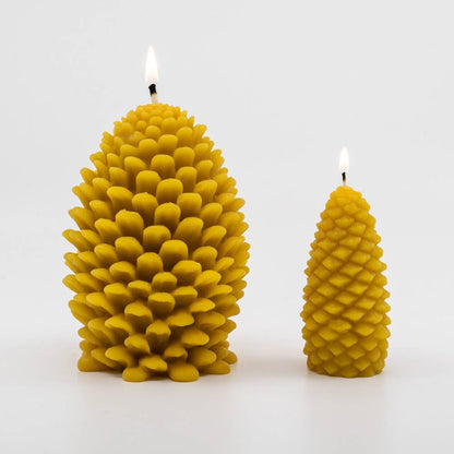 Two Beeswax Pine Cone Candles, one small and one large, both lit.