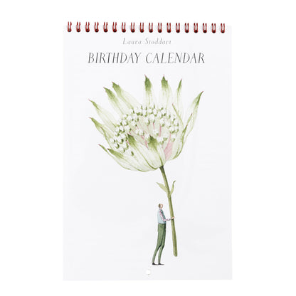 The front cover of the wire bound calendar features a stylized illustration of a man holding a gigantic green bloom on a white background under the title &quot;Laura Stoddart Birthday Calendar&quot;. 