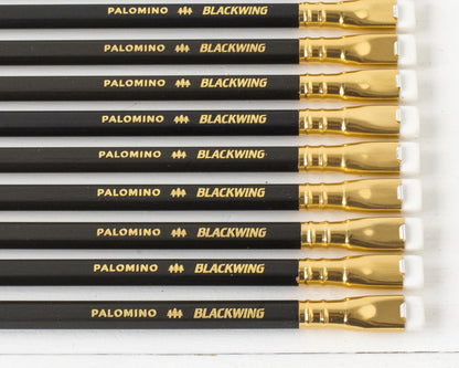 A collection of Blackwing Matte Pencil Set of 12 pencils arranged in parallel on a white surface.