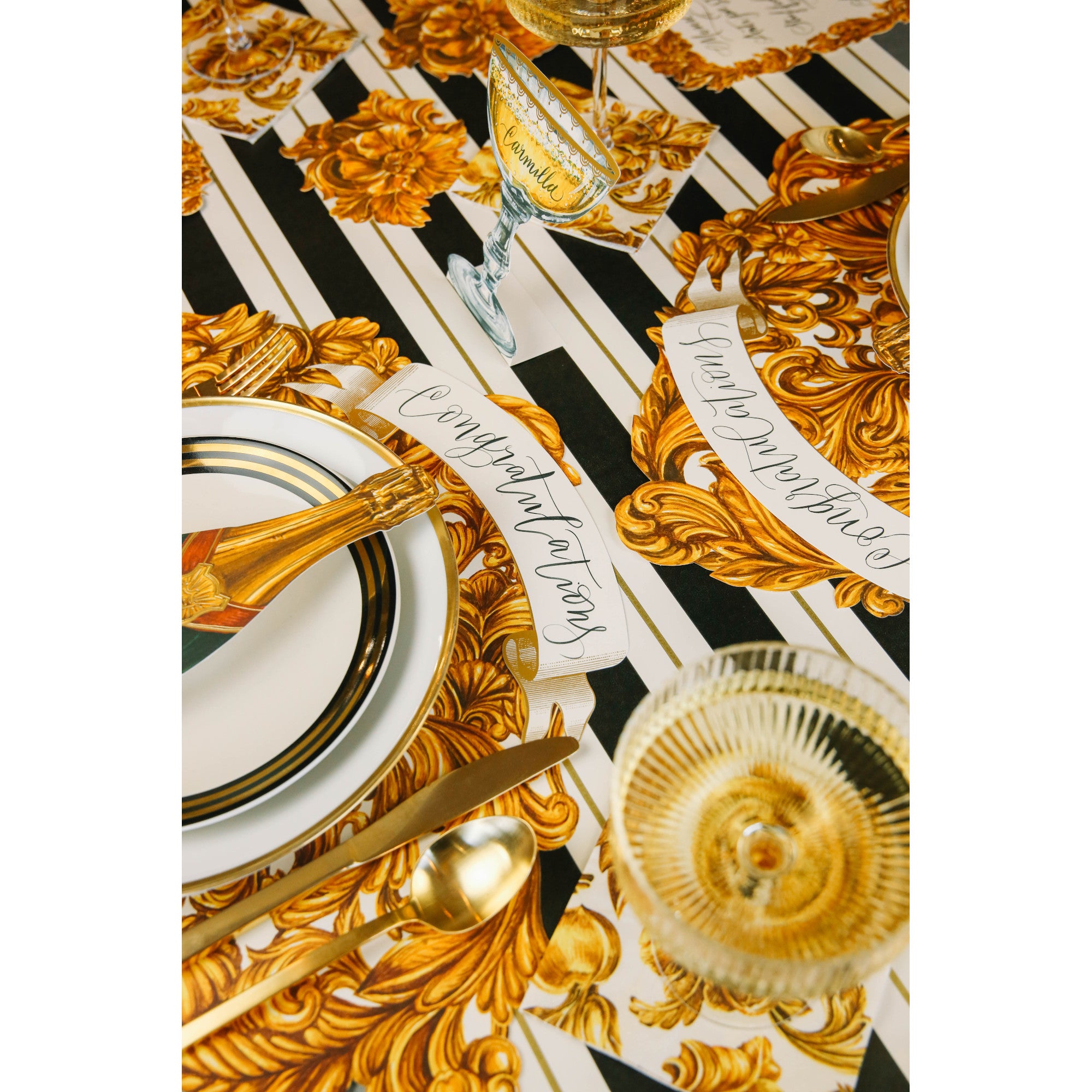 The Black &amp; Gold Awning Stripe Runner under an elegant gold-motif table setting.