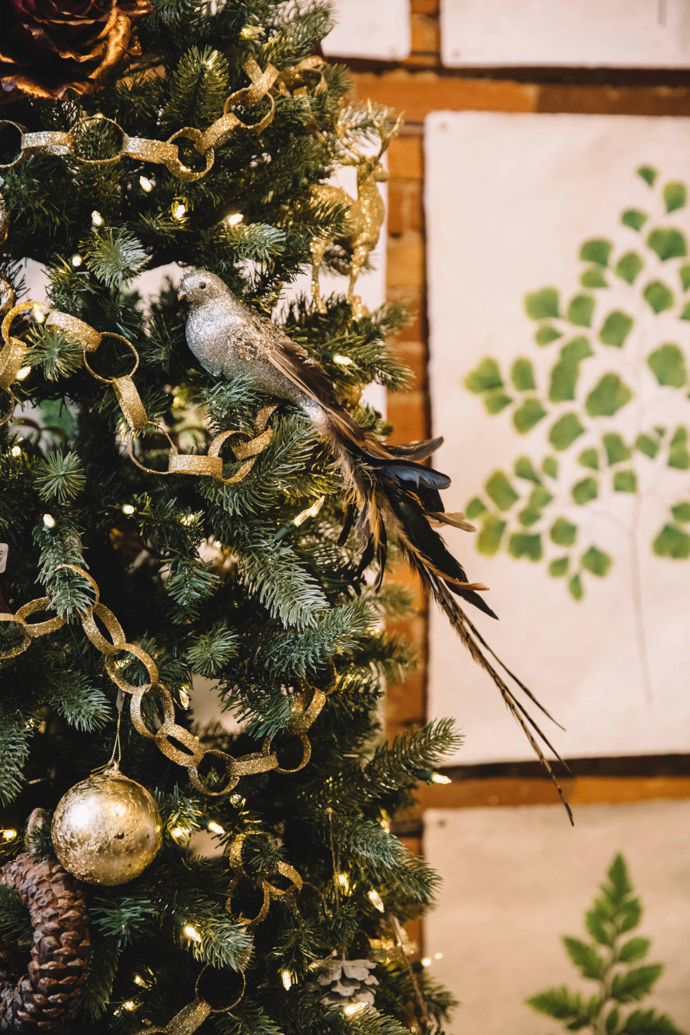 silver glitter bird ornament in tree