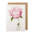 A white greeting card featuring a stylized illustration of a man holding a gigantic pink peony bloom by the stem, with the included kraft paper envelope tucked behind. 