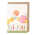 A Balloon Party Greeting Card illustrated by Laura Stoddart with people holding large pink, orange, yellow and white balloons.