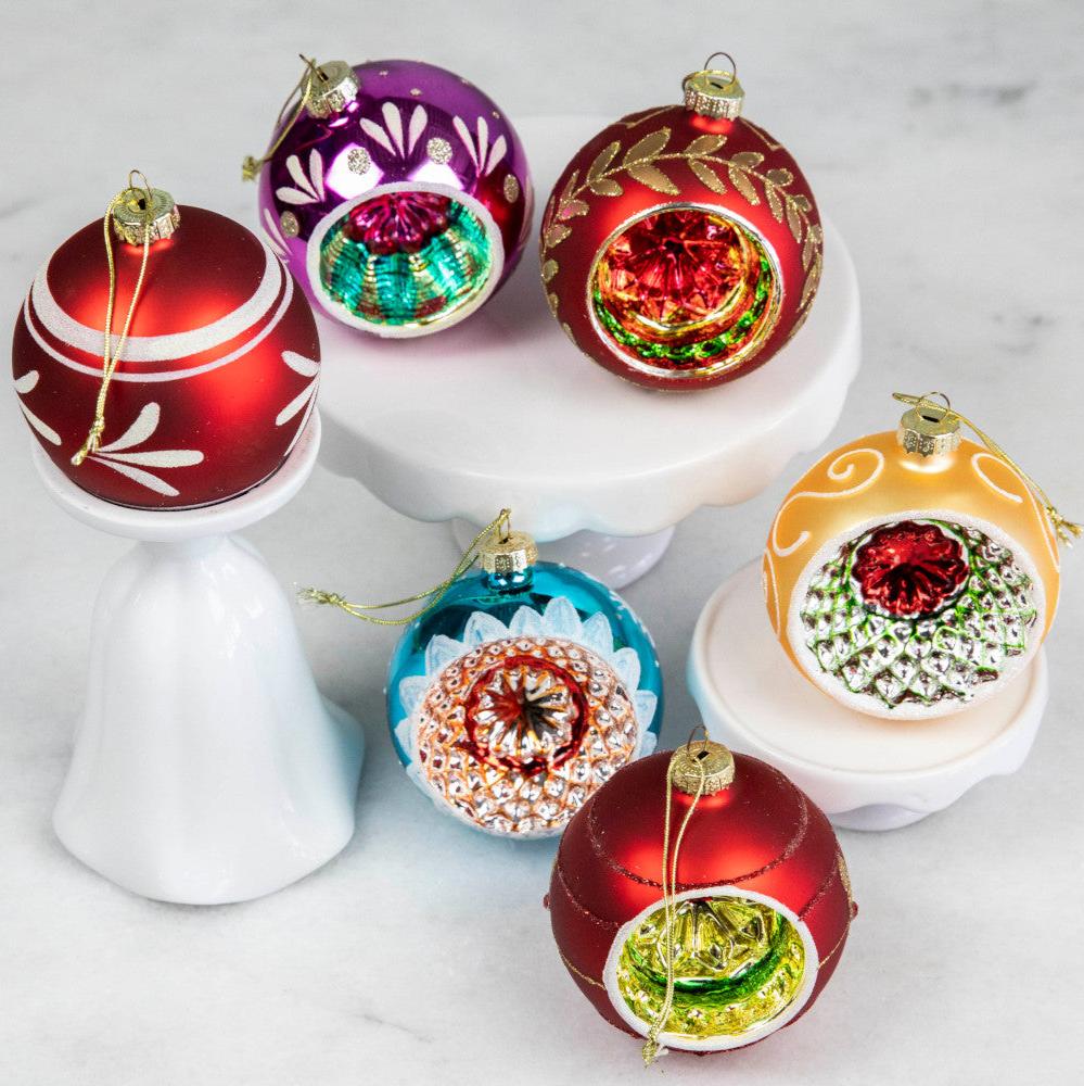 Six vintage inspired Reflector Ornaments displayed on a table.