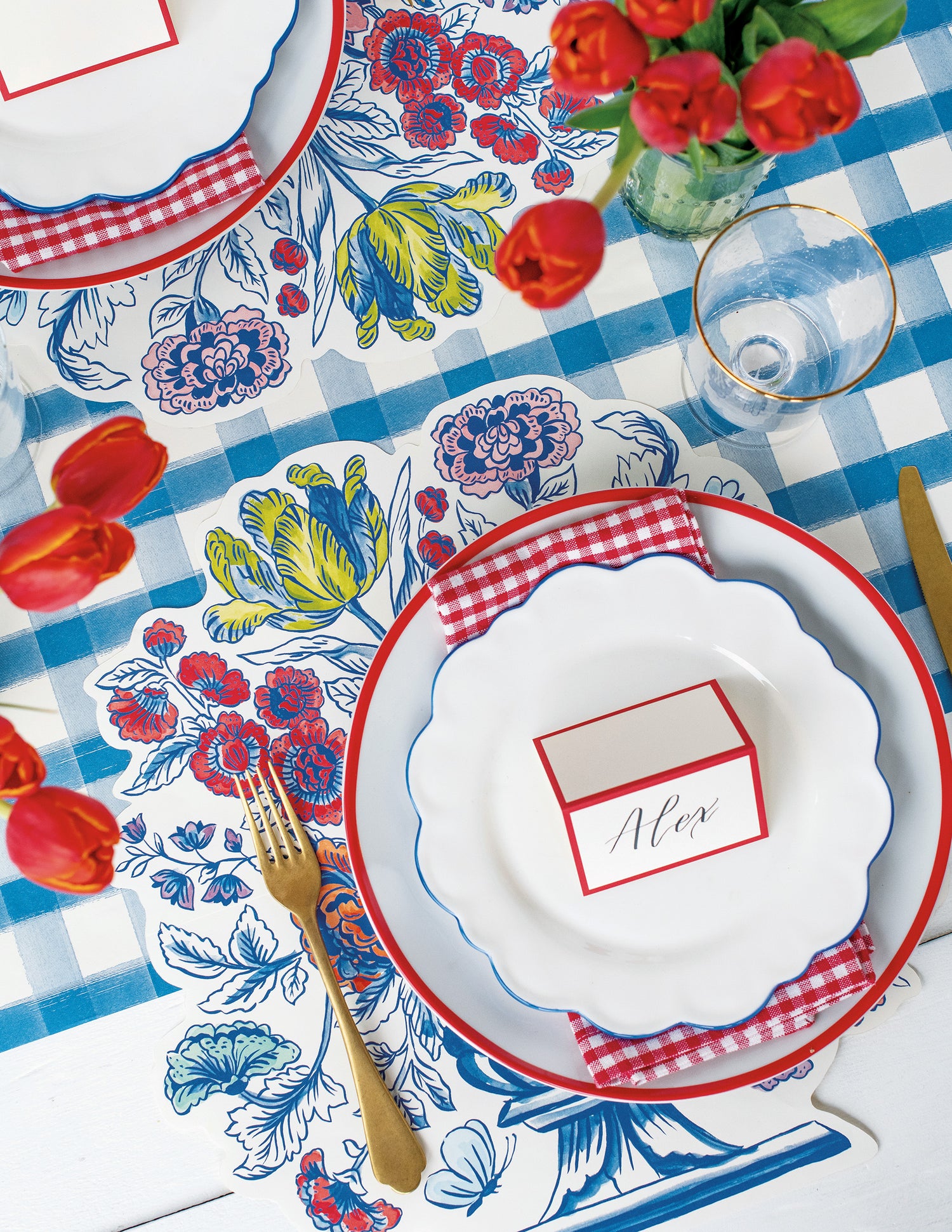 A Blue Painted Check Runner under an elegant floral table setting, from above.