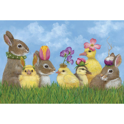 An illustrated group of seven brown bunnies, yellow chicks and yellow ducklings sitting in green grass with springtime botanicals on their heads, on a vibrant blue sky background.