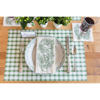 An Oak Leaves Guest Napkin centered on a gold-rimmed white plate in an elegant, fall-themed place setting.