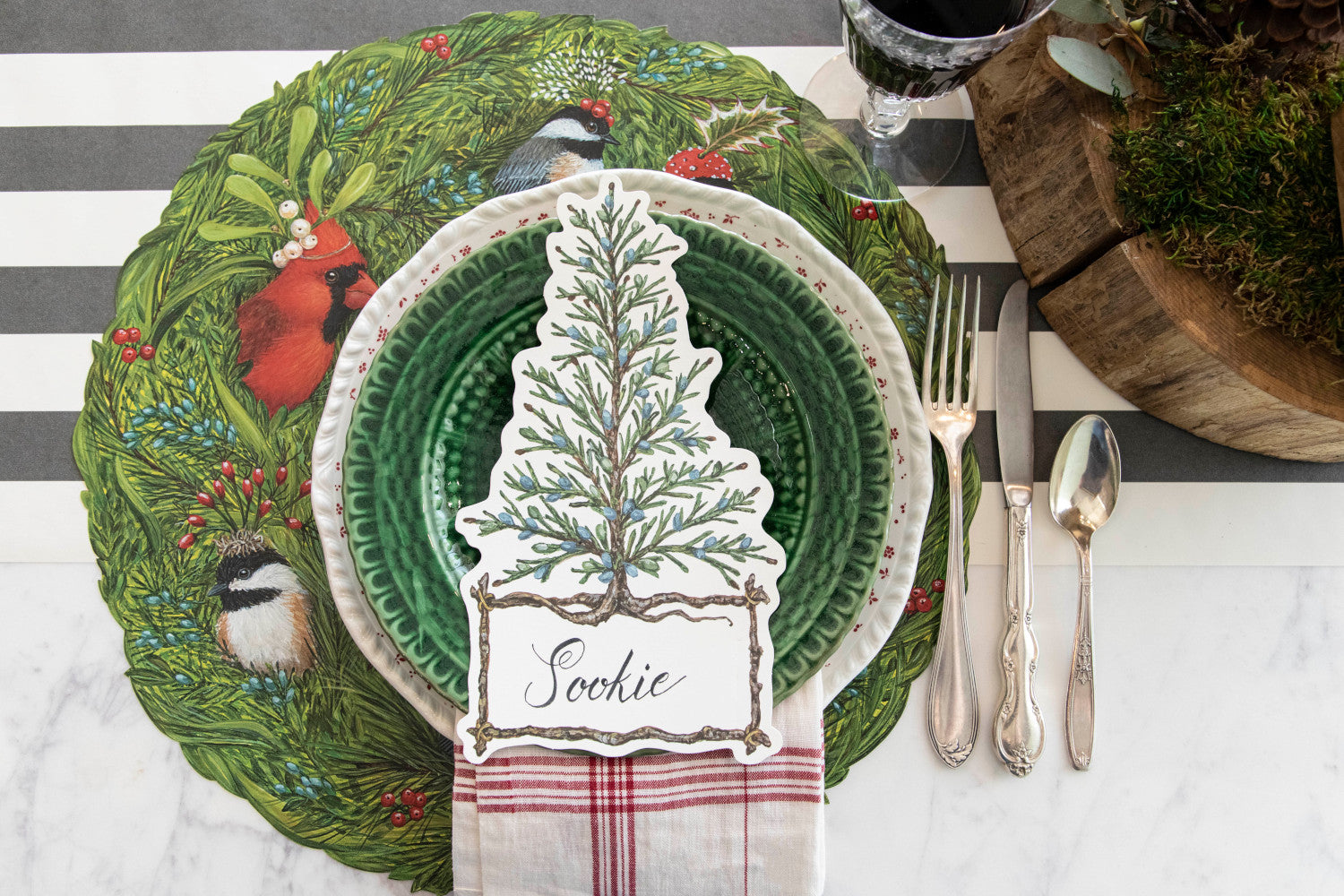 The Die-cut Winter Songbirds Placemat under a festive winter-themed place setting, from above.