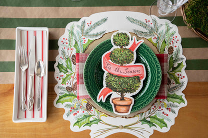 The Die-cut Christmas Sprigs Placemat under a festive holiday place setting, from above.