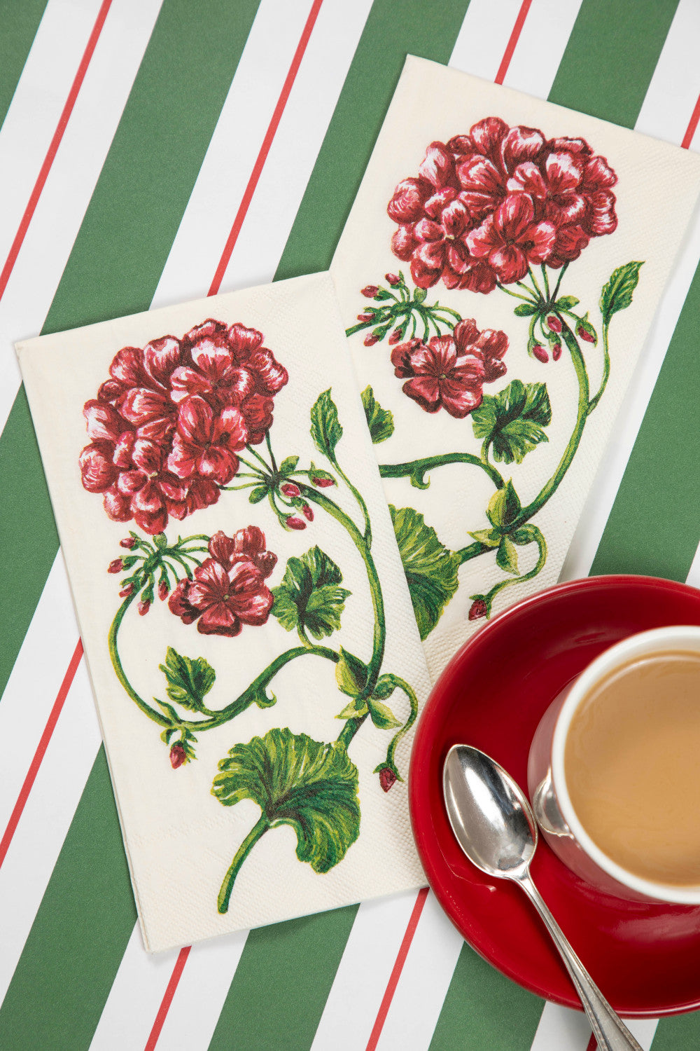 The Green &amp; Red Awning Stripe Runner under a Christmas-themed place setting with a cup of coffee.