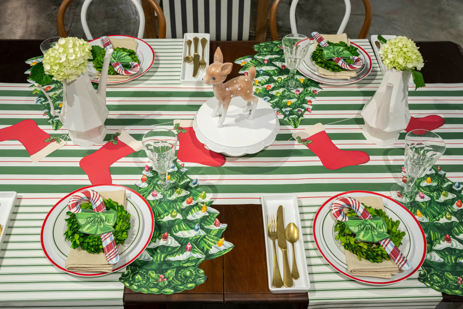 The Green &amp; Red Awning Stripe Runner under a festive Christmas-themed table setting for four.