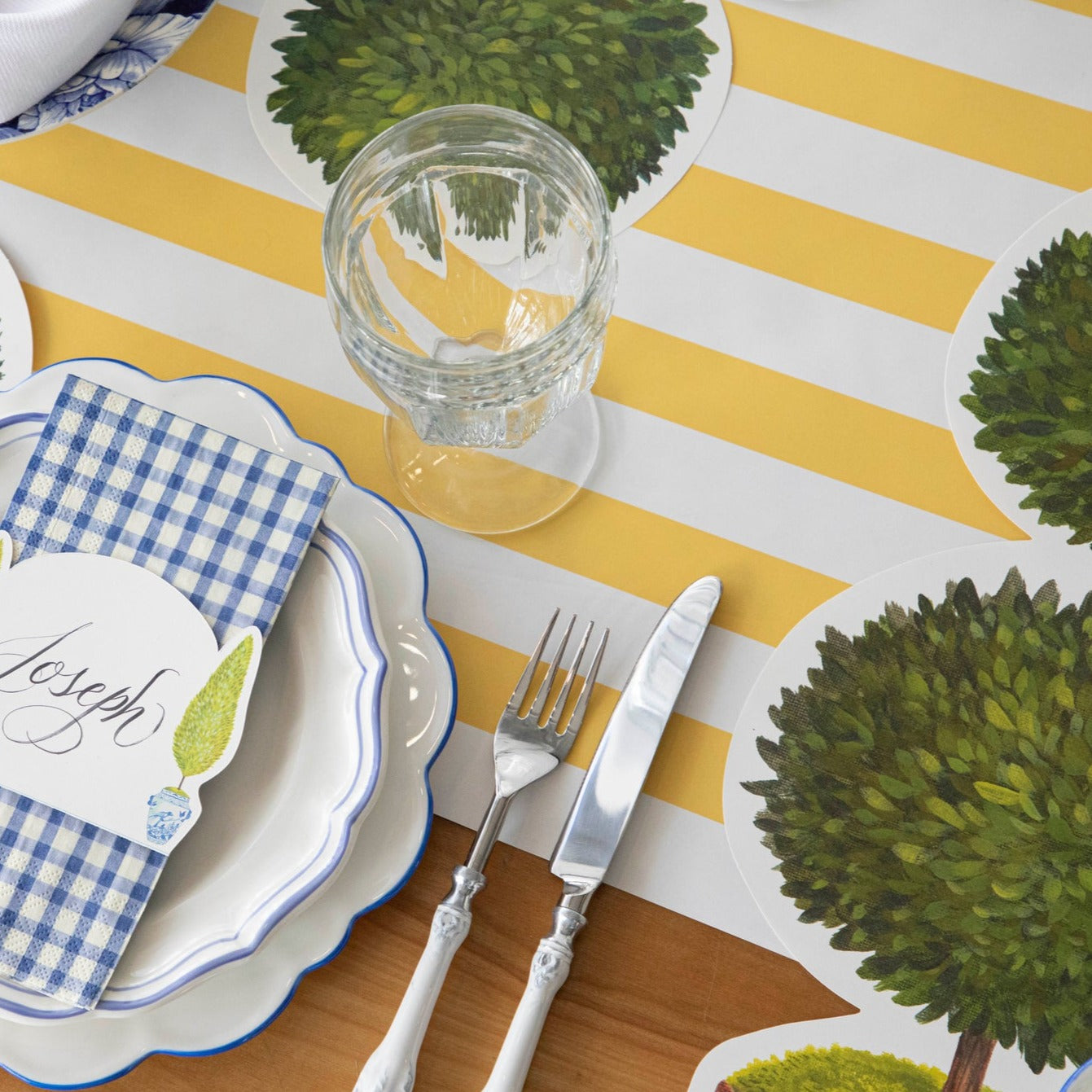 A Marigold Classic Stripe Runner from Hester &amp; Cook under an elegant place setting.
