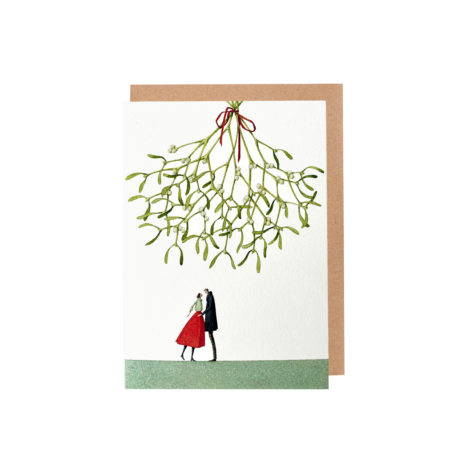 The Christmas Kiss Greeting Card featuring a watercolor illustration of a couple standing on a green field under a gigantic sprig of mistletoe hanging from above over a white background, with included brown kraft paper envelope.