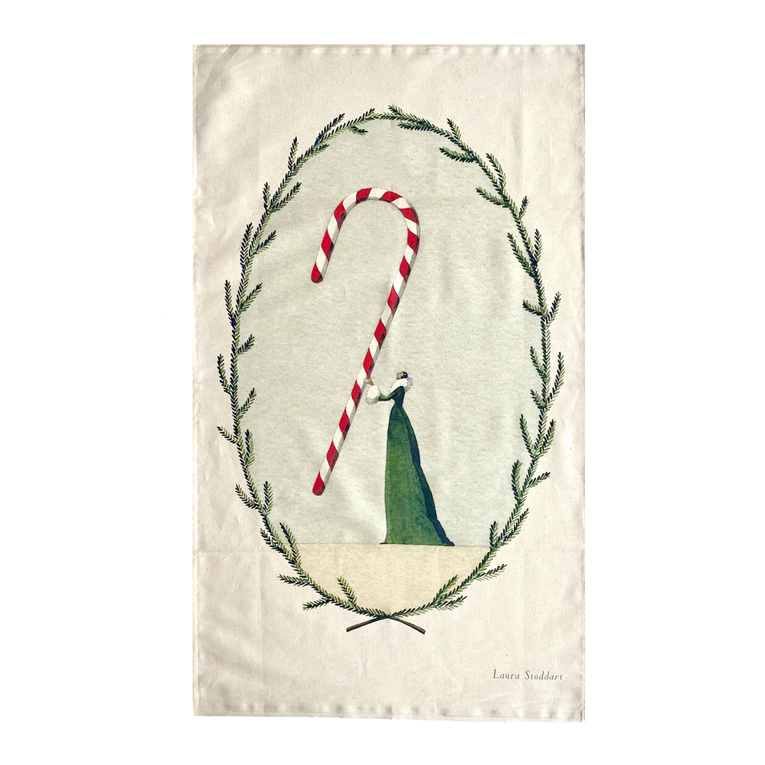 A tea towel featuring an illustration of a woman in a long green dress holding a gigantic candy cane within a frame of winter foliage.