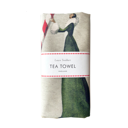 The Candy Cane Tea Towel, illustrated by Laura Stoddart, folded and wrapped in paper retail packaging. 