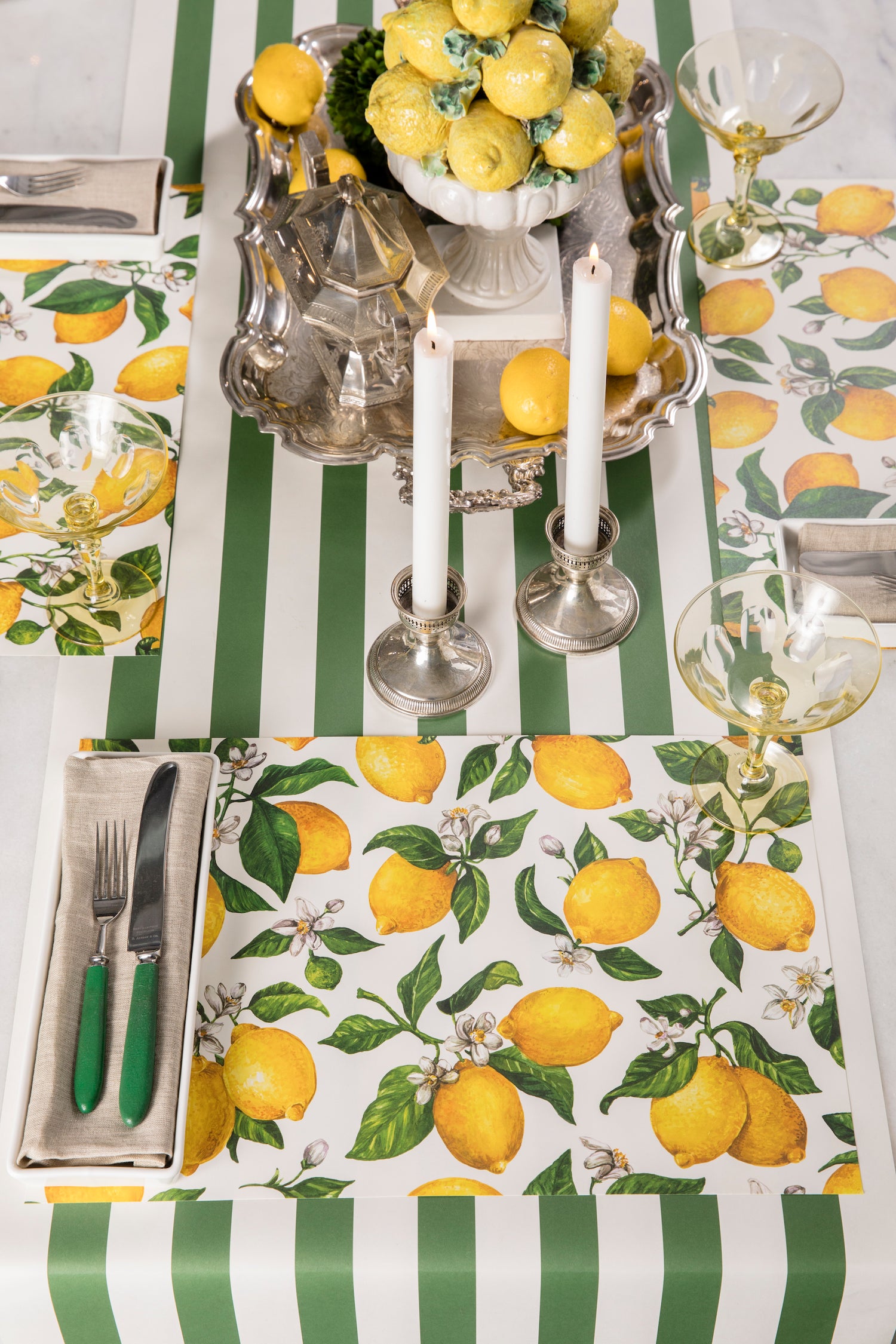 Three Lemon Placemats in a bright summer-themed table setting for three, sans plates.