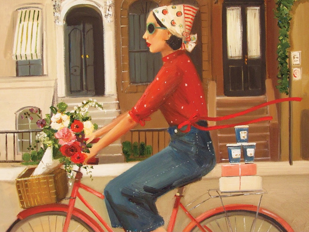 A Brownstones Puzzle of a woman riding a red bicycle with a basket of flowers in front of a building with windows and doors, crafted by Janet Hill, by New York Puzzle Company.