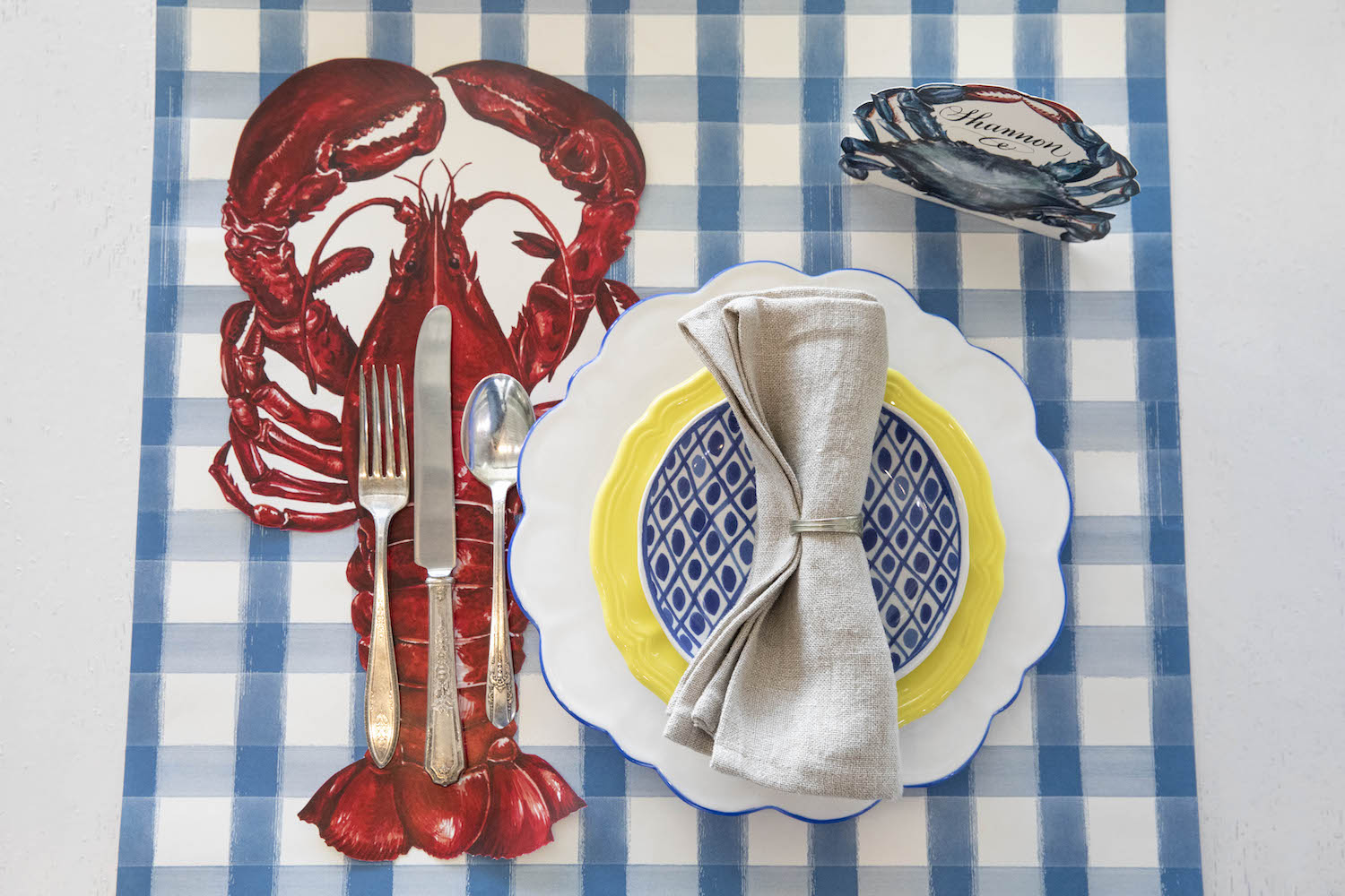 The Blue Painted Check Runner under a nautical-themed place setting.