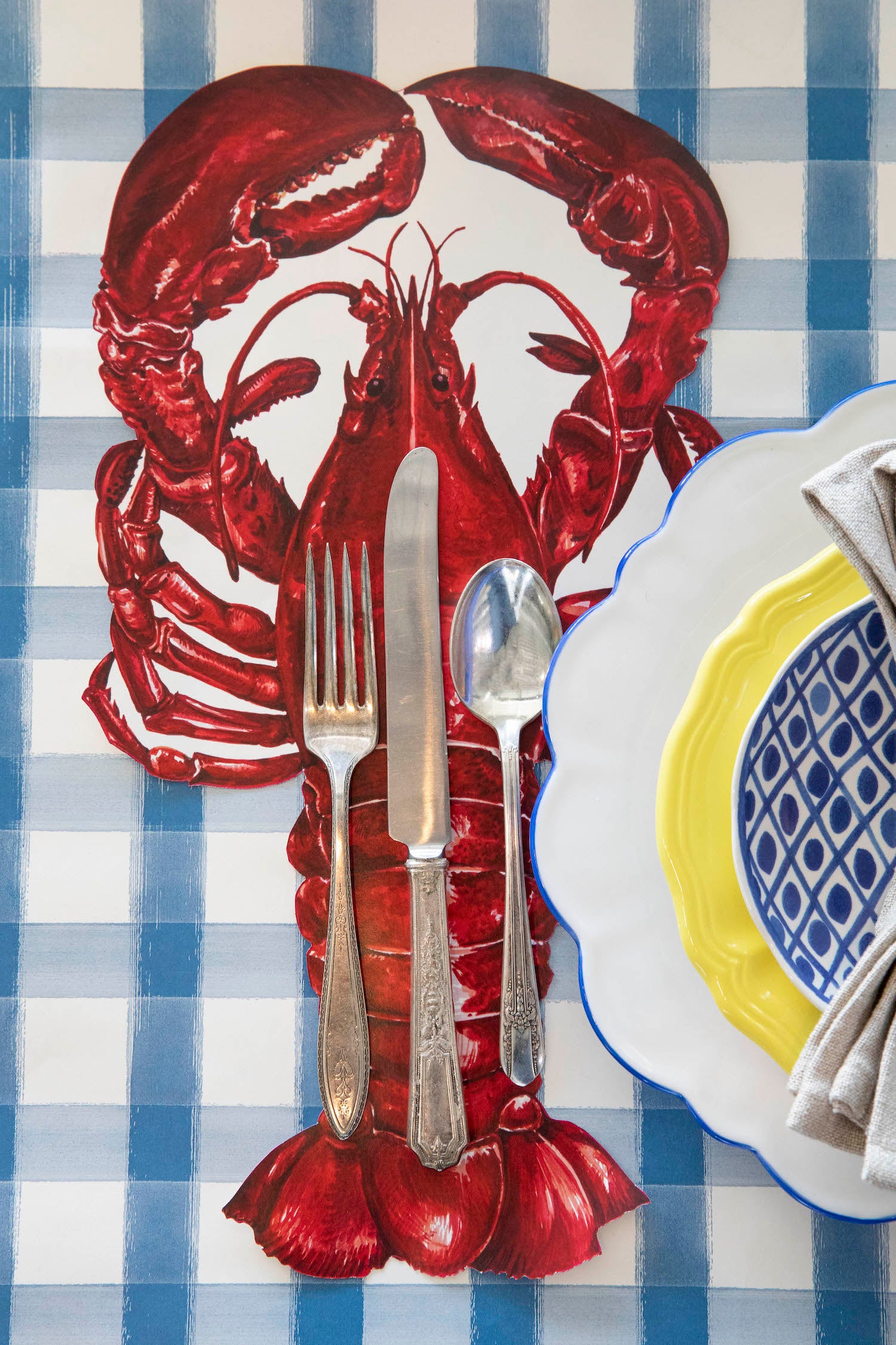 The Die-cut Lobster Placemat under the cutlery in an elegant place setting, from above.