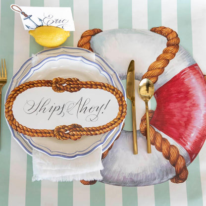 The Die-cut Life Preserver Placemat under an elegant nautical-themed place setting, from above.