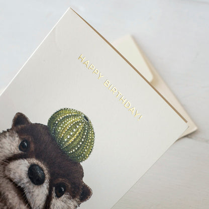 An adorable Othello Otter Card featuring Othello Otter sporting a unique cactus hat, designed by Vicki Sawyer and produced by Hester &amp; Cook.