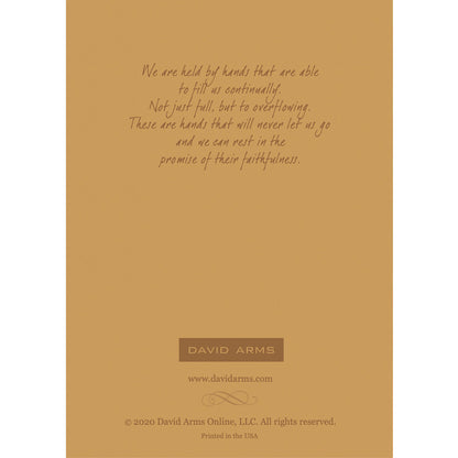 The tan back side of the greeting card, featuring a quote from artist David Arms.