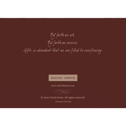 The deep brown back side of the greeting card featuring a quote from artist David Arms.