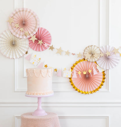 Paper fans in an assortment of pinks, creams and golds.  