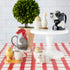 A red and white checkered tablecloth adorned with quirky Farm Animal Ceramics from the British brand, Quail.