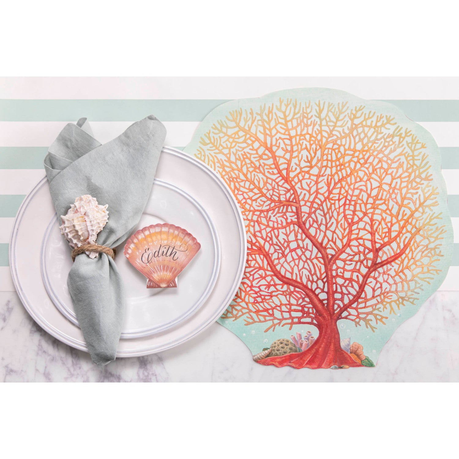 The Die-cut Coral Placemat under an elegant beach-themed place setting, from above. 