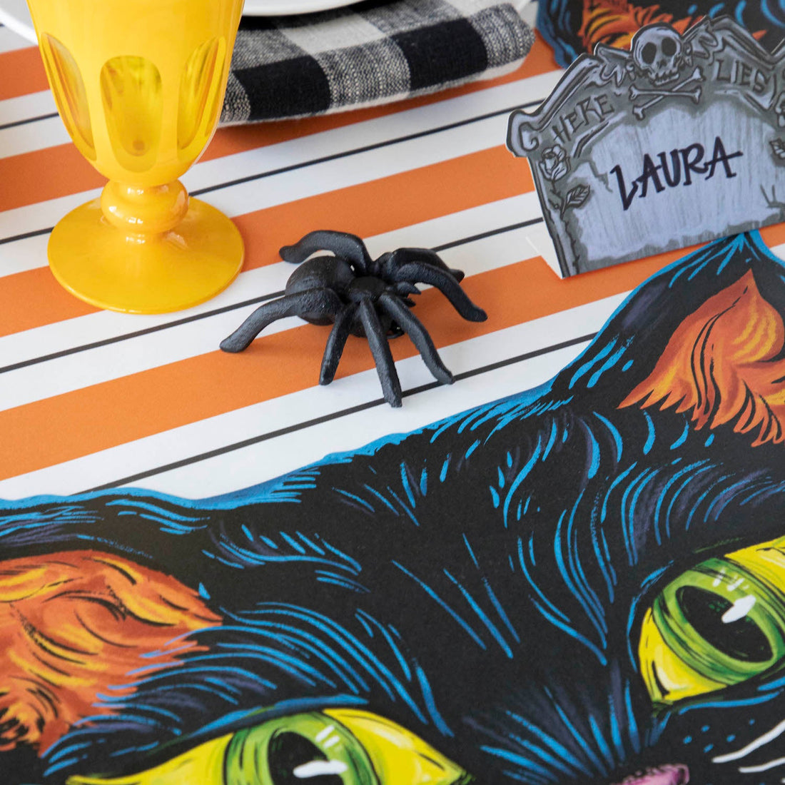 The Orange and Black Awning Stripe Runner under a spooky Halloween-themed tablescape.