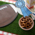 A bowl of pretzels and a football on a Talking Tables Artificial Grass Table Runner.