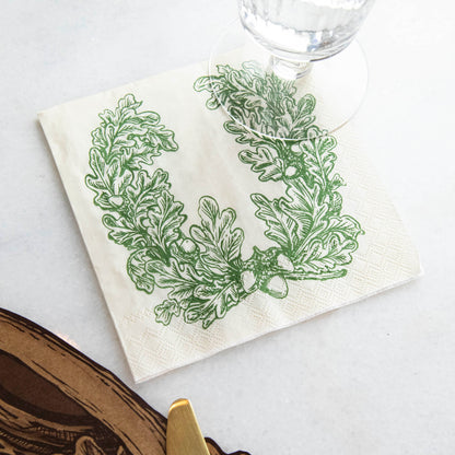 An Oak Leaves Cocktail Napkin under a water glass in a rustic place setting.