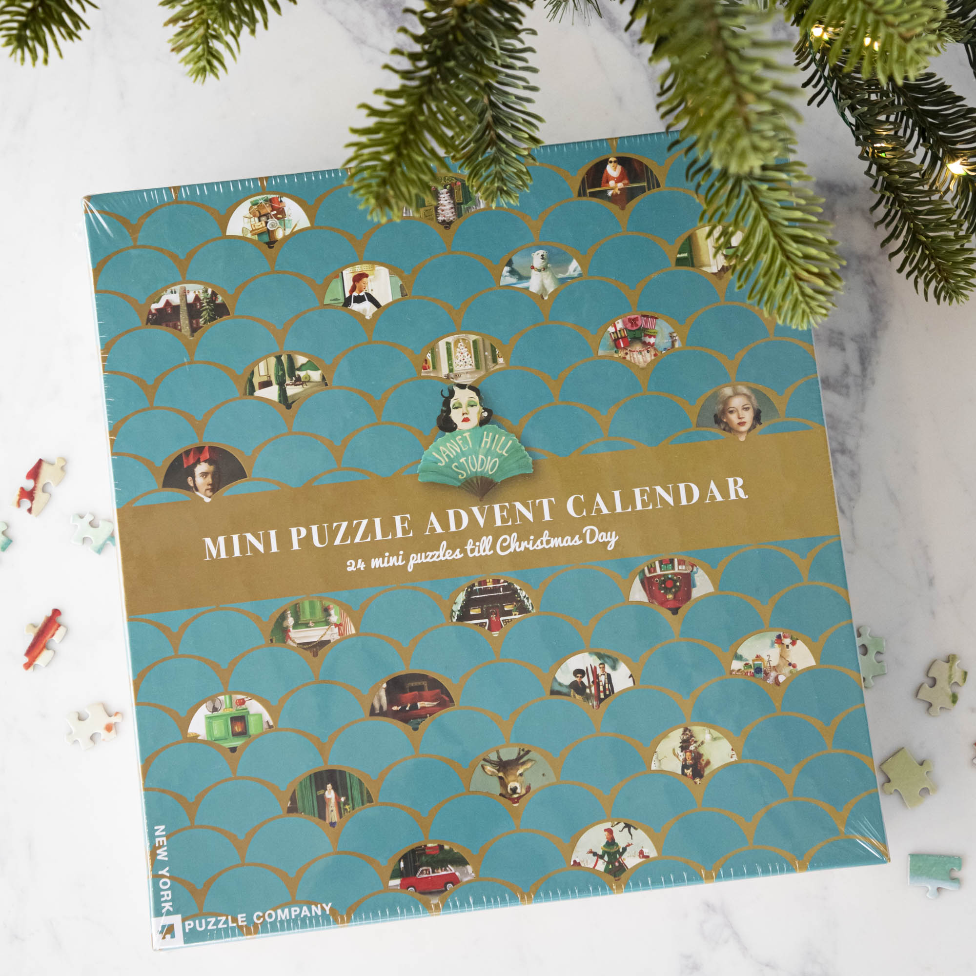 Overhead shot of the Janet Hill Mini Puzzle Advent Calendar featuring images from the Janet Hill Studio.