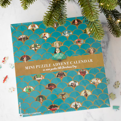 Overhead shot of the Janet Hill Mini Puzzle Advent Calendar featuring images from the Janet Hill Studio.