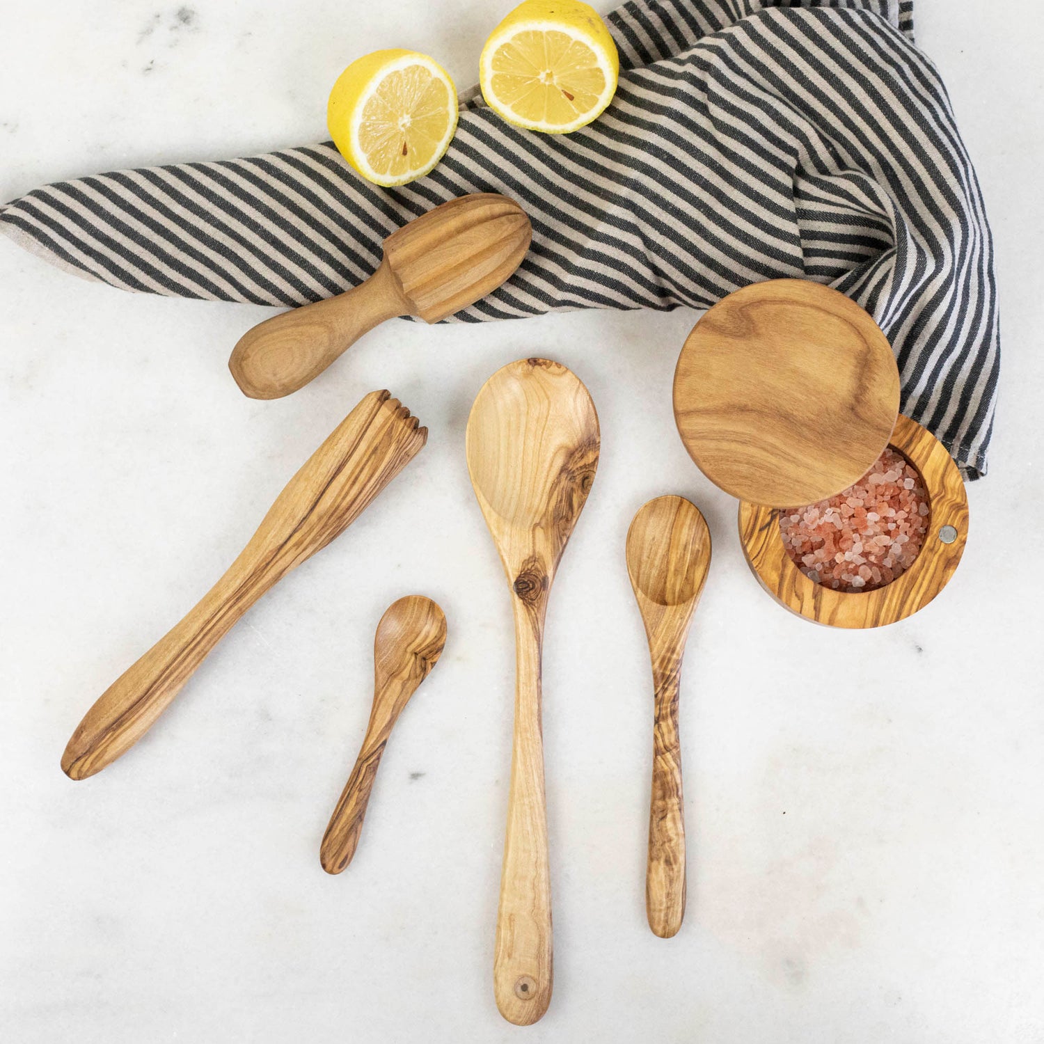 A set of nonporous Natural Olivewood Olivewood Spoons with lemons and salt.