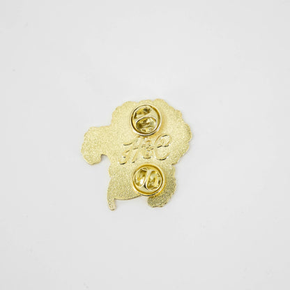 A Geranium Enamel Pin from Hester &amp; Cook featuring a stylized gold poodle.